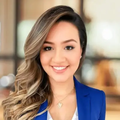 Mulher sorridente usando blazer azul em ambiente profissional